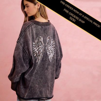 Back of women's edgy grunge revival sweatshirt with large sequin angel wings