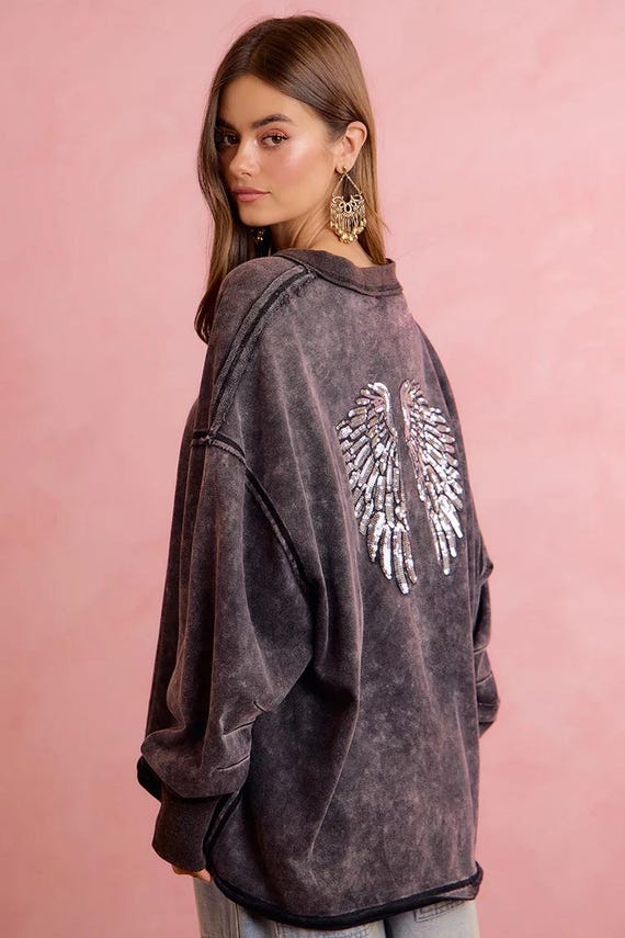 Side view of women's dropped shoulder sequin wing sweatshirt