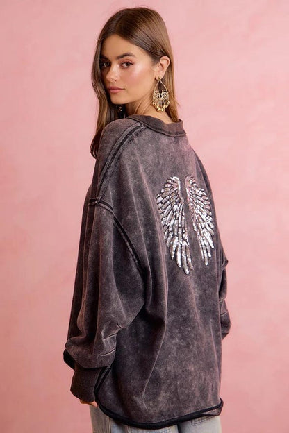 Side view of women's dropped shoulder sequin wing sweatshirt