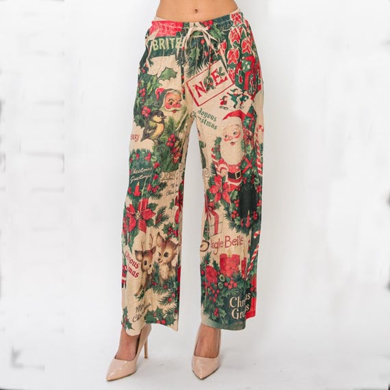 Women's wide leg Christmas print pants, front view, with vintage Santa and reindeer pattern