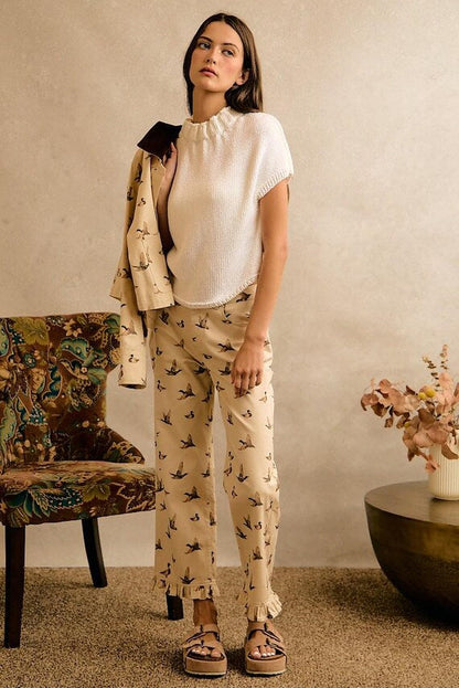 Cream wide-leg cotton denim pants with mallard duck print, ruffle hem, styled for a playful Cottagecore aesthetic.