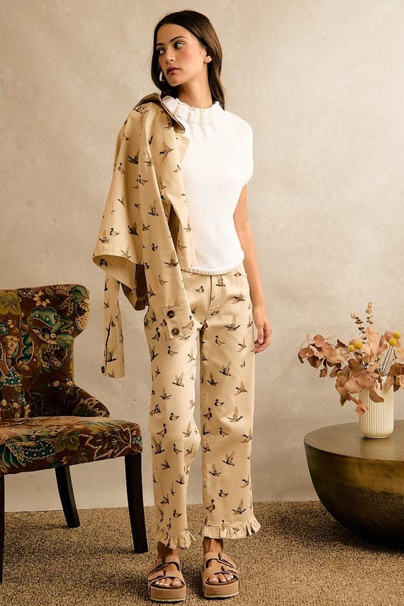 Women's cottagecore cream wide-leg cotton denim pants with a mallard duck print and ruffle hem.