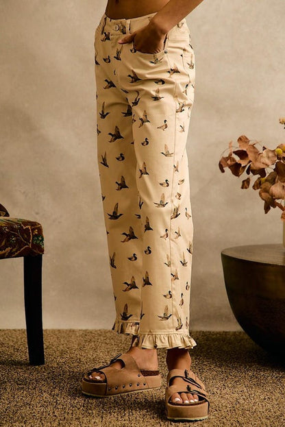 Cottagecore cream cotton denim wide leg pants with an allover mallard duck print and a ruffle hem at the ankles.